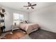 Bright bedroom features natural light from the window and a rustic hide rug at 16415 W Oyer Ln, Surprise, AZ 85387