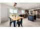 Bright kitchen features an island, stainless steel appliances, and space for a dining table at 16415 W Oyer Ln, Surprise, AZ 85387