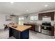 The kitchen view with stainless steel appliances, kitchen island with butcher block top and dining area at 16415 W Oyer Ln, Surprise, AZ 85387