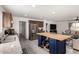 Open kitchen view includes stainless steel appliances, island with storage and seamless flow into the living room at 16415 W Oyer Ln, Surprise, AZ 85387