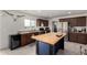 This kitchen boasts an island with butcher block top, stainless steel refrigerator and sleek dark cabinets at 16415 W Oyer Ln, Surprise, AZ 85387