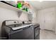 Laundry room with machines and overhead storage at 16415 W Oyer Ln, Surprise, AZ 85387