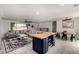 Open concept living room featuring a comfortable sectional sofa and a kitchen island with seating at 16415 W Oyer Ln, Surprise, AZ 85387