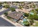 Aerial view of property showcasing a swimming pool, patio, and the surrounding neighborhood at 1656 W Meseto Cir, Mesa, AZ 85202