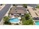 Aerial view of backyard featuring pool, patio, and well-maintained landscaping at 1656 W Meseto Cir, Mesa, AZ 85202