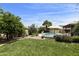 Beautiful backyard with lush grass, a variety of cacti, and a refreshing swimming pool at 1656 W Meseto Cir, Mesa, AZ 85202