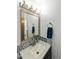 Bathroom vanity featuring granite countertop and stylish blue, gray and white backsplash at 1656 W Meseto Cir, Mesa, AZ 85202
