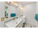 Bright bathroom featuring dual sinks with gold fixtures and attractive design elements at 1656 W Meseto Cir, Mesa, AZ 85202