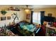 Bedroom features a window, ceiling fan, and decorative shelves, perfect for a  at 1656 W Meseto Cir, Mesa, AZ 85202
