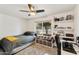 Bright bedroom featuring a ceiling fan, large window, and shelves displaying decorative objects at 1656 W Meseto Cir, Mesa, AZ 85202