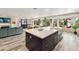 Open floor plan with kitchen island with sink and seating, plus view to Gathering room at 1656 W Meseto Cir, Mesa, AZ 85202