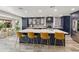 Open kitchen with a large island, barstool seating, custom cabinets, and modern appliances at 1656 W Meseto Cir, Mesa, AZ 85202