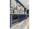 This modern kitchen features custom cabinetry, wine fridge and an amazing tile backsplash at 1656 W Meseto Cir, Mesa, AZ 85202