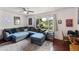 Comfortable living room featuring a sectional sofa, natural light, and stylish decor at 1656 W Meseto Cir, Mesa, AZ 85202