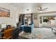 Open living area features a comfortable sofa, a ceiling fan and a sliding door to the pool at 1656 W Meseto Cir, Mesa, AZ 85202