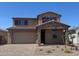 Charming two-story home featuring a stone-accented entry, paver driveway, and coordinated exterior color scheme at 16760 W Hope Dr, Surprise, AZ 85388
