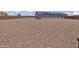 Large gravel backyard with a single-story home featuring solar panels at 18100 W College Dr, Goodyear, AZ 85395