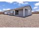 Single-story home features a covered patio and a gravel backyard at 18100 W College Dr, Goodyear, AZ 85395