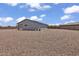 Large gravel backyard with a single-story home featuring solar panels at 18100 W College Dr, Goodyear, AZ 85395