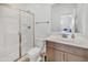 Bathroom with a glass shower, modern toilet and a wooden vanity with a sink at 18100 W College Dr, Goodyear, AZ 85395