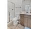Bright bathroom featuring a walk-in shower with glass doors, toilet, and modern vanity with a sink at 18100 W College Dr, Goodyear, AZ 85395