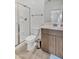 Clean bathroom with a shower and vanity with cabinet storage at 18100 W College Dr, Goodyear, AZ 85395