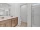 Bathroom with double sinks, framed mirror, wood-style cabinets and a glass-enclosed shower at 18100 W College Dr, Goodyear, AZ 85395