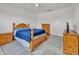 Bedroom featuring a wooden bed frame, wooden nightstands, and patterned rugs at 18100 W College Dr, Goodyear, AZ 85395