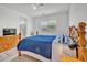 Cozy bedroom featuring a wooden bed frame, a window with a view, and an attached bathroom at 18100 W College Dr, Goodyear, AZ 85395