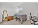Cozy bedroom with a comfortable bed, mirror and a desk setup at 18100 W College Dr, Goodyear, AZ 85395