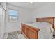 Bright bedroom with hardwood floors and a window overlooking the neighborhood at 18100 W College Dr, Goodyear, AZ 85395