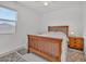 Bright bedroom featuring a wooden bed frame, bedside table and lots of natural light at 18100 W College Dr, Goodyear, AZ 85395