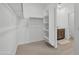 Spacious walk-in closet with shelving and hanging rods; a bathroom is accessible through the closet at 18100 W College Dr, Goodyear, AZ 85395