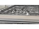Gas cooktop with stainless steel knobs on white quartz countertop at 18100 W College Dr, Goodyear, AZ 85395