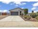 Charming single-story home with a two-car garage and desert landscaping at 18100 W College Dr, Goodyear, AZ 85395