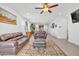 Spacious living room with a ceiling fan, hardwood floors, and modern décor at 18100 W College Dr, Goodyear, AZ 85395