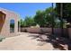 Private backyard featuring brick-paved patio, beautiful plants, and lush trees at 1861 E Bendix Dr, Tempe, AZ 85283