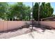 Spacious backyard featuring brick-paved patio, gravel, and mature trees at 1861 E Bendix Dr, Tempe, AZ 85283
