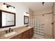 Luxurious bathroom featuring double sinks, granite counters, a tile mosaic, and a glass block shower at 1861 E Bendix Dr, Tempe, AZ 85283