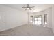 Spacious bedroom with neutral walls, carpet flooring, ceiling fan, and access to the outdoors, creating a cozy and inviting retreat at 1861 E Bendix Dr, Tempe, AZ 85283