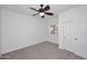 Clean bedroom offers soft carpet, neutral walls, and a ceiling fan at 1861 E Bendix Dr, Tempe, AZ 85283