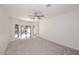 Bright bedroom with neutral walls, carpet flooring, ceiling fan and sliding glass doors, offering a relaxing and inviting space at 1861 E Bendix Dr, Tempe, AZ 85283