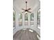 Sunlit breakfast nook with large arched windows, providing a bright and inviting space with wood flooring and a ceiling fan at 1861 E Bendix Dr, Tempe, AZ 85283