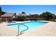 Community swimming pool with lounge area, surrounded by lush landscaping and desert foliage at 1861 E Bendix Dr, Tempe, AZ 85283