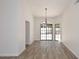 Bright dining room with neutral walls, wood-like flooring, pendant lighting and french doors to outside entertaining area at 1861 E Bendix Dr, Tempe, AZ 85283