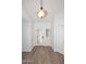 Bright foyer with wood-look tile flooring, white walls, and decorative front door at 1861 E Bendix Dr, Tempe, AZ 85283