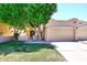 Charming home with mature shade tree, low stucco walls, and lush green grass at 1861 E Bendix Dr, Tempe, AZ 85283