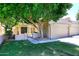 Charming home with mature shade tree, low stucco walls, and lush green grass at 1861 E Bendix Dr, Tempe, AZ 85283