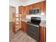 Kitchen featuring wooden cabinets, granite countertops, stainless steel oven and pullout storage for modern functionality and design at 1861 E Bendix Dr, Tempe, AZ 85283
