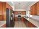 Updated kitchen with stainless steel appliances, wood cabinets, and granite countertops at 1861 E Bendix Dr, Tempe, AZ 85283
